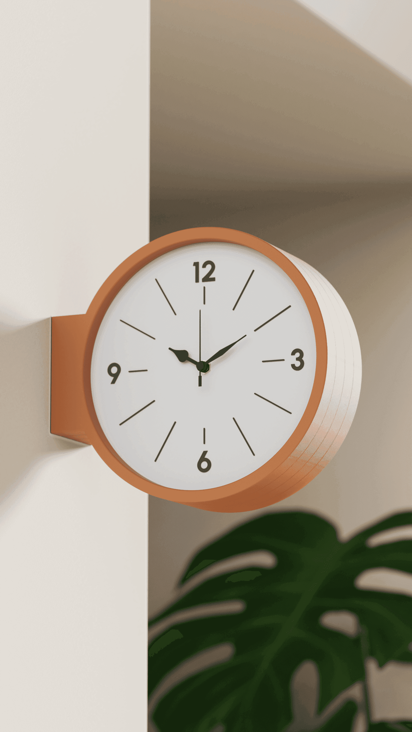 ORBI round wall clock in terracotta orange, mounted on a wall